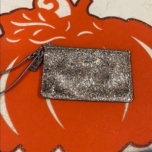 Coach woman’s gold sparkle wristlet wallet